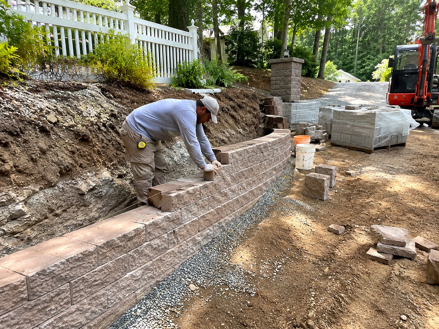 Installing a stacked stone retaining wall on a hillside